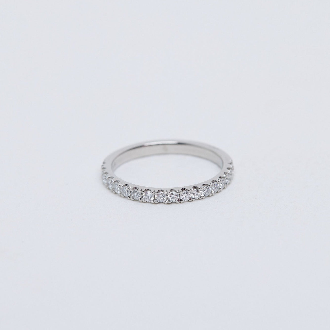 Round brilliant diamond band, split claw setting in platinum
