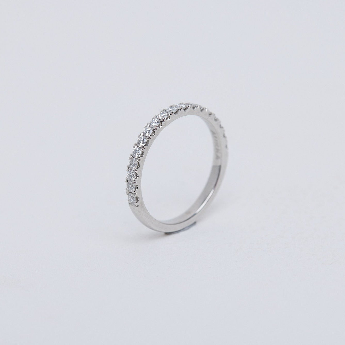 Round brilliant diamond band, split claw setting in platinum