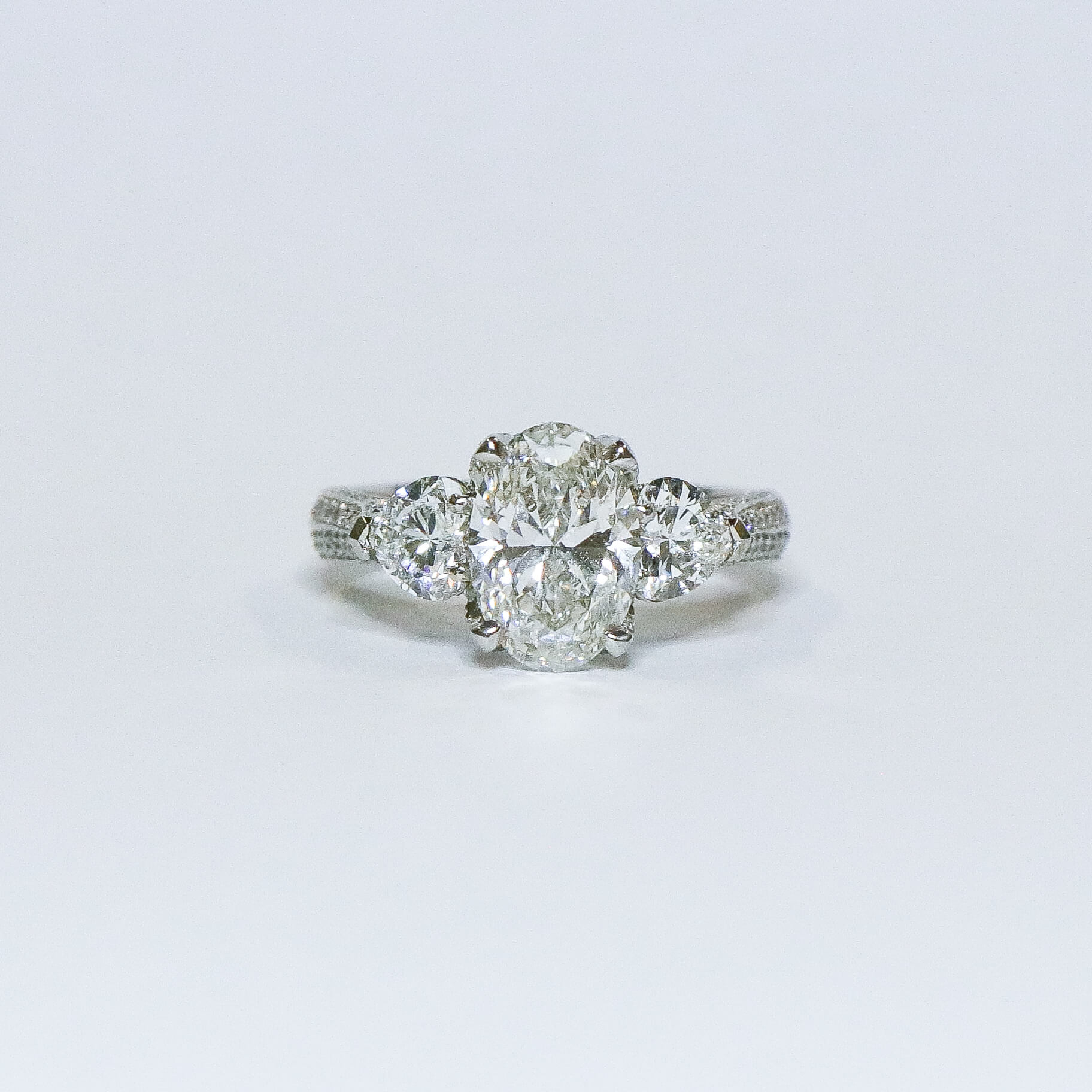 Oval diamond with heart side diamonds  engagement ring