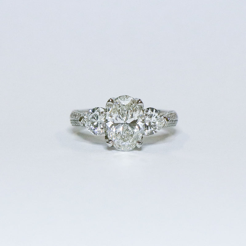 Oval diamond with heart side diamonds ring