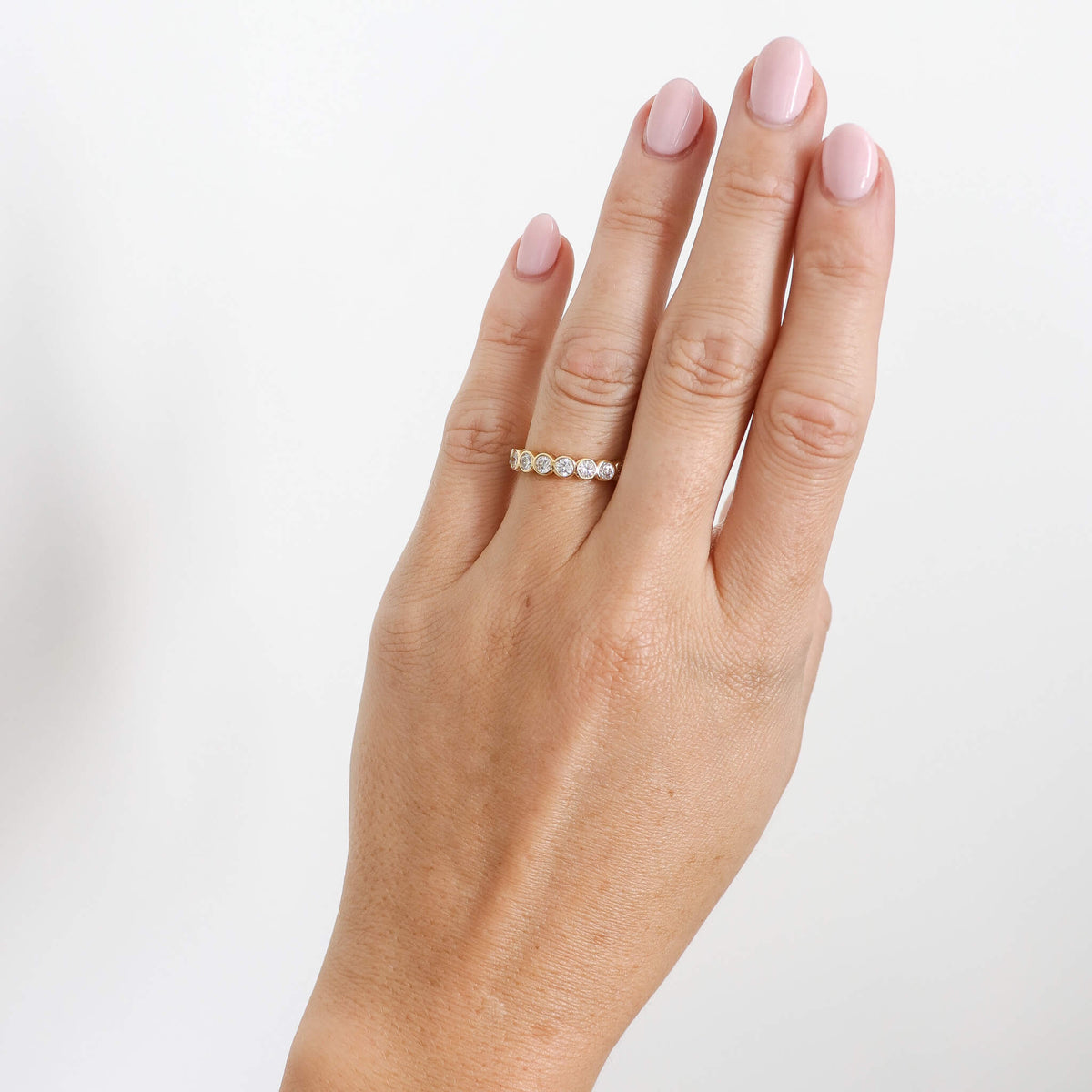 Bezel full eternity ring on hand